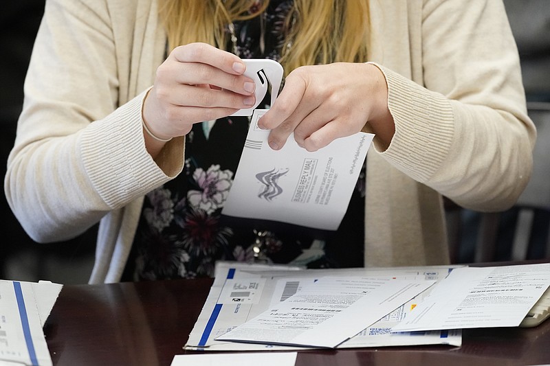 The Associated Press / A Luzerne County, Pennsylvania, worker canvases ballots that were postmarked by Election Day but didn't arrive until the Friday after Election Day at 5 p.m.