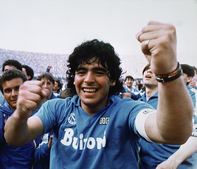 AP photo by Massimo Sambucetti / Argentine soccer superstar Diego Maradona cheers after Napoli, his professional club team, clinched its first Italian major league title on May 10, 1987.