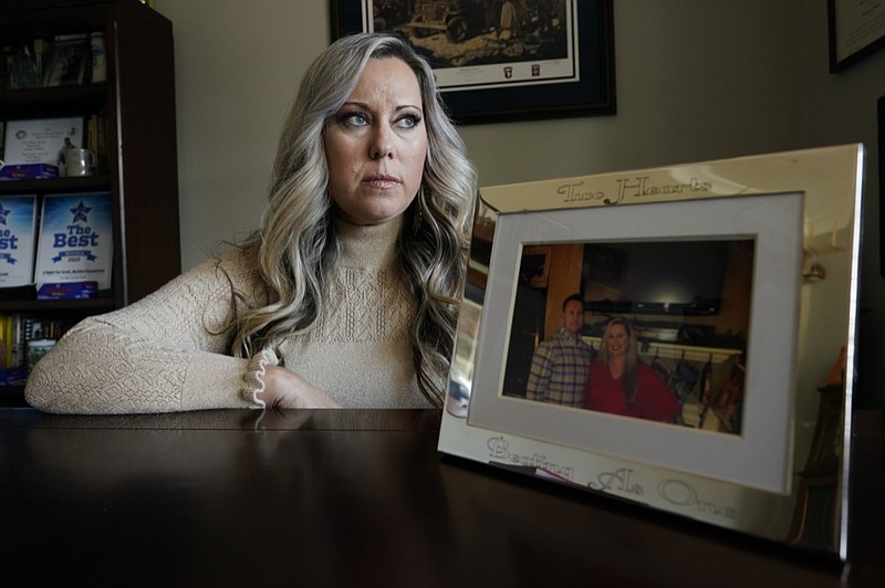 Jill Cichowicz, an advocate for opioid addiction treatment, displays a photo of her and her brother, Scott Zebnwski, who died of an opioid overdose at age 38, in her home in Midlothian, Va., Tuesday, Nov. 24, 2020. (AP Photo/Steve Helber)



