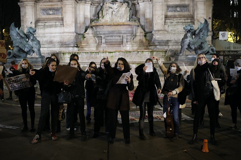 Women gather at the Saint Michel fountain Wednesday, Nov. 25, 2020 in Paris. With domestic violence on the rise amid the pandemic, activists are holding protests Wednesday from France to Turkey and world dignitaries are trying to find ways to protect millions of women killed or abused every year by their partners. (AP Photo/Francois Mori)


