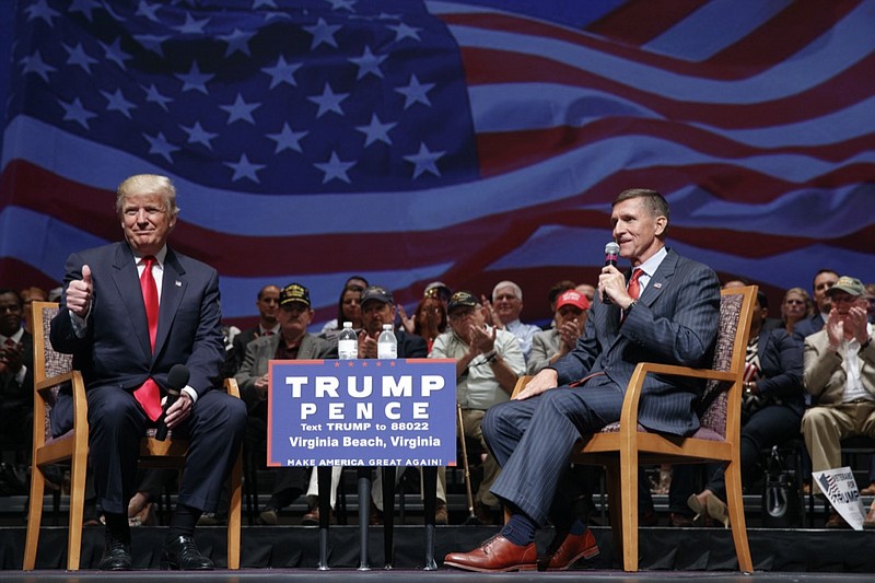 FILE - Then-presidential candidate Donald Trump gives a thumbs up as he speaks with retired Lt. Gen. Michael Flynn during a town hall, Tuesday, Sept. 6, 2016, in Virginia Beach, Va. President Donald Trump has pardoned Michael Flynn, taking direct aim in the final days of his administration at a Russia investigation that he has long insisted was motivated by political bias. Trump announced the pardon on Wednesday, Nov. 25, 2020 calling it his "Great Honor." (AP Photo/Evan Vucci, file)