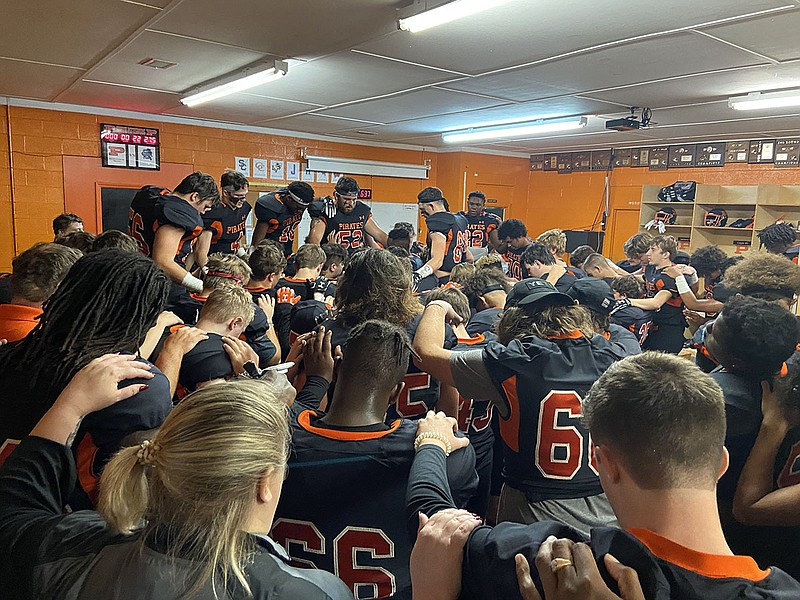 Staff photo by Stephen Hargis / South Pittsburg football players bow their heads in prayer before a recent playoff game. The Pirates are one of four area teams thankful to have the opportunity to continue competing in this year's TSSAA playoffs, with the coronavirus pandemic's effect on the season adding more gratitude than usual to the opportunity to practice during Thanksgiving week.