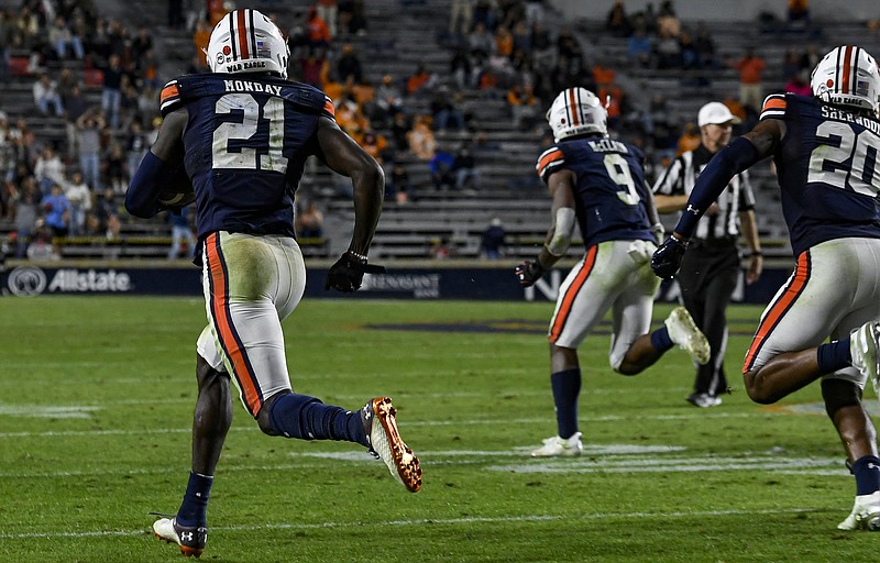 Todd Van Emst/AU Athletics / Auburn safety Smoke Monday receives a defensive escort on his way to a 100-yard interception return for a touchdown during last Saturday night's 30-17 win over Tennessee.