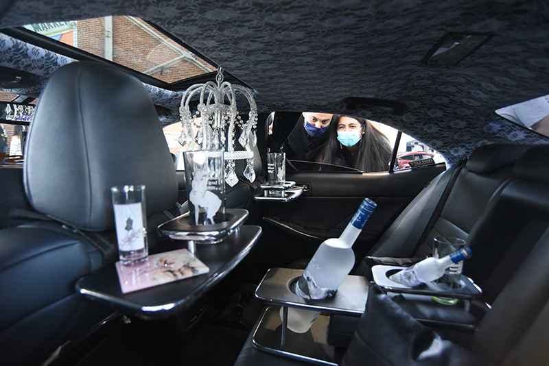 Staff photo by Matt Hamilton / Marcus Rojo and Mariela Vazquez check out the interior of a car on display.