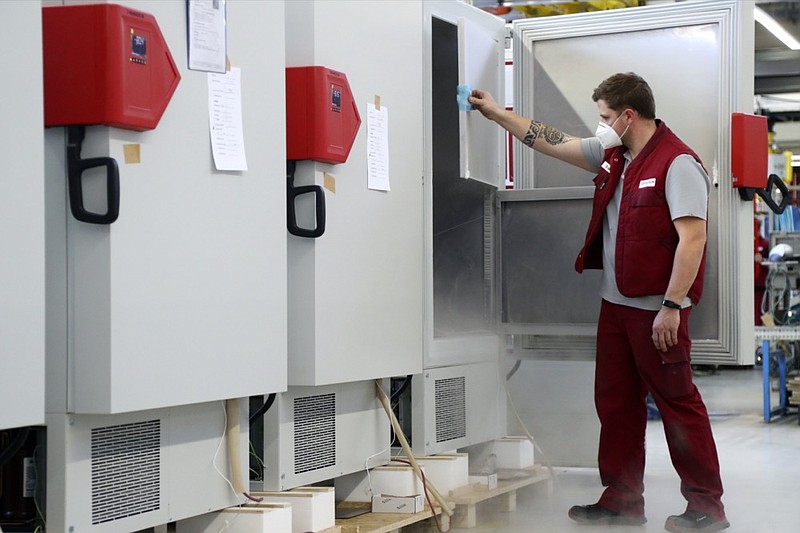 File -- In this Tuesday, Nov. 24, 2020 file photo an employee of Binder, the world's largest manufacturer of serial-production environmental simulation chambers for scientific or industrial laboratories, checks an ultra low temperature freezer in Tuttlingen, Germany. Germany prepares for the vaccination of the German population during the upcoming month. (AP Photo/Matthias Schrader, file)


