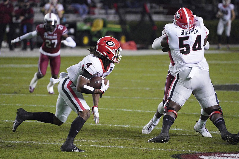 AP photo by Sean Rayford / Georgia running back James Cook carries the ball during the first half of Saturday night's SEC game at South Carolina.