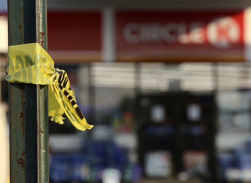 Staff photo by C.B. Schmelter / Crime scene tape hangs off of a sign post outside of the Circle K gas station on the corner of Hixson Pike and Cloverdale Drive on Friday, July 21, in Hixson, Tenn. According to Chattanooga police, one person was found dead at the gas station that morning due to a gunshot.