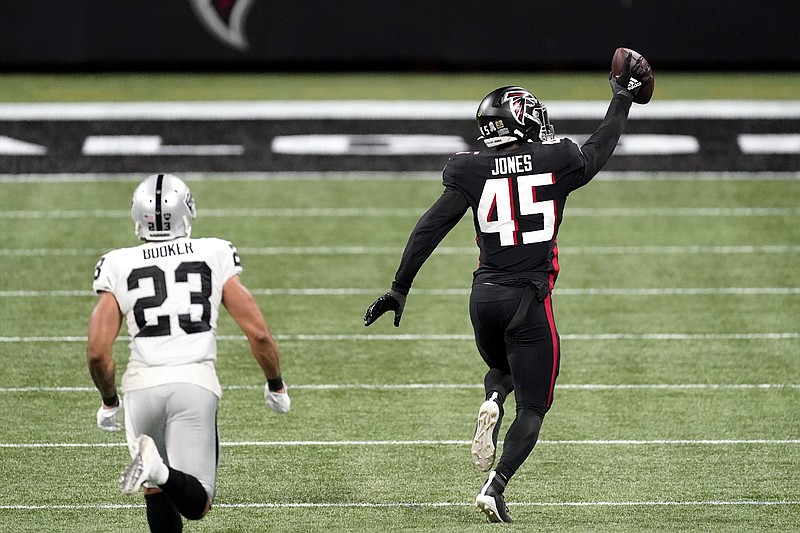 AP photo by John Bazemore / Atlanta Falcons linebacker Deion Jones returns an interception for a touchdown with Las Vegas Raiders running back Devontae Booker trailing during the second half of Sunday's game in Atlanta.