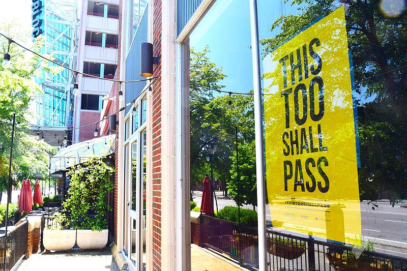 Staff Photo by Robin Rudd / A sign on the closed Easy Bistro claims, "This Too Shall Pass," on May 2, 2020. In the background is the closed High Point Climbing and Fitness and Mellow Mushroom.
