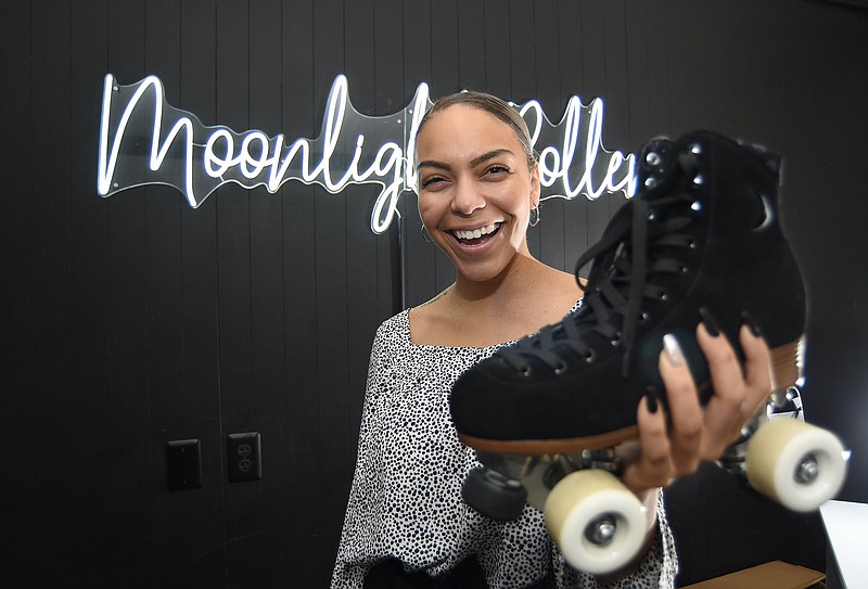 Staff Photo by Matt Hamilton / Adrienne Cooper holds the Night Fever style Moon Boot at Moonlight Roller in Chattanooga.