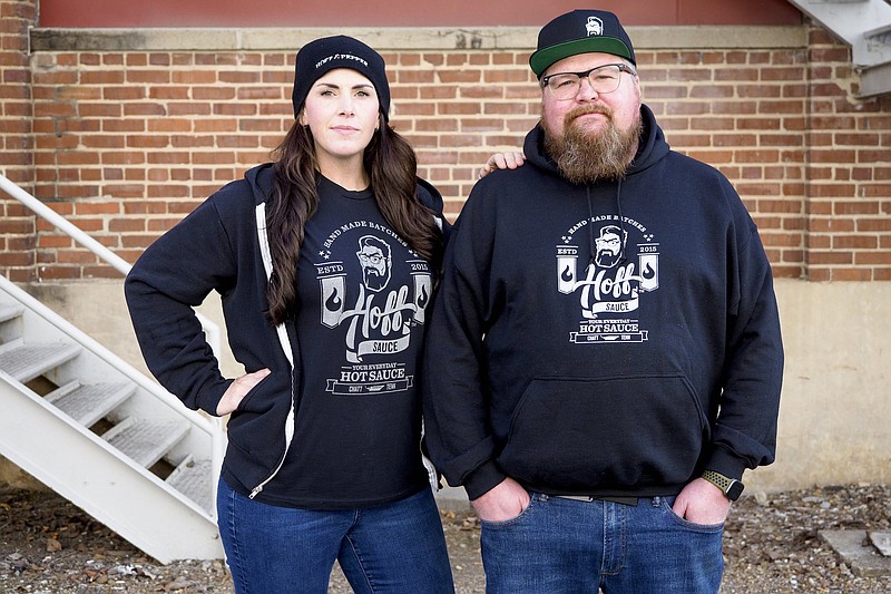 Staff photo by C.B. Schmelter / Sporting Hoff & Pepper gear, Aaron Hoffman, right, and his wife Pepper pose behind the Hamilton County INCubator in November.