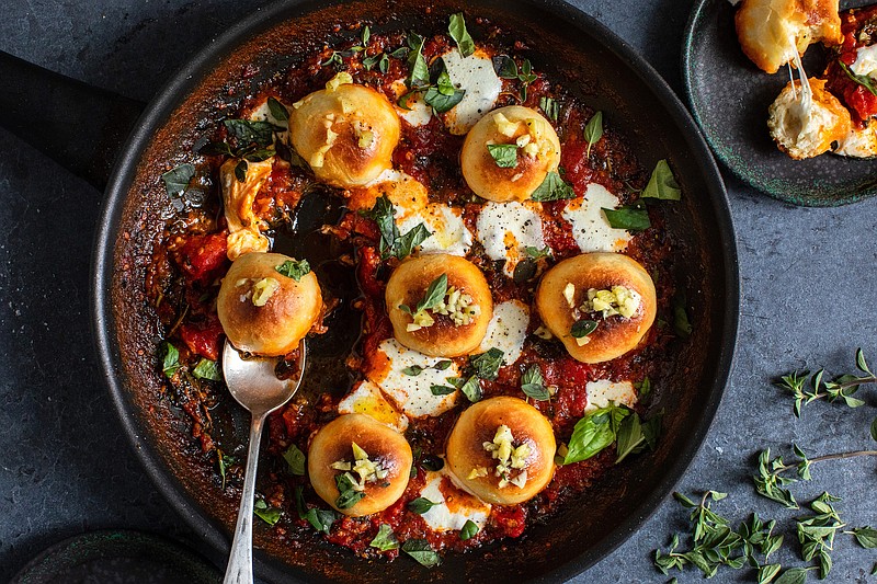 Think of these cheesy bread balls in tomato sauce, a kind of deconstructed pizza, as a tribute to the little things. / Photo by Andrew Scrivani/The New York Times