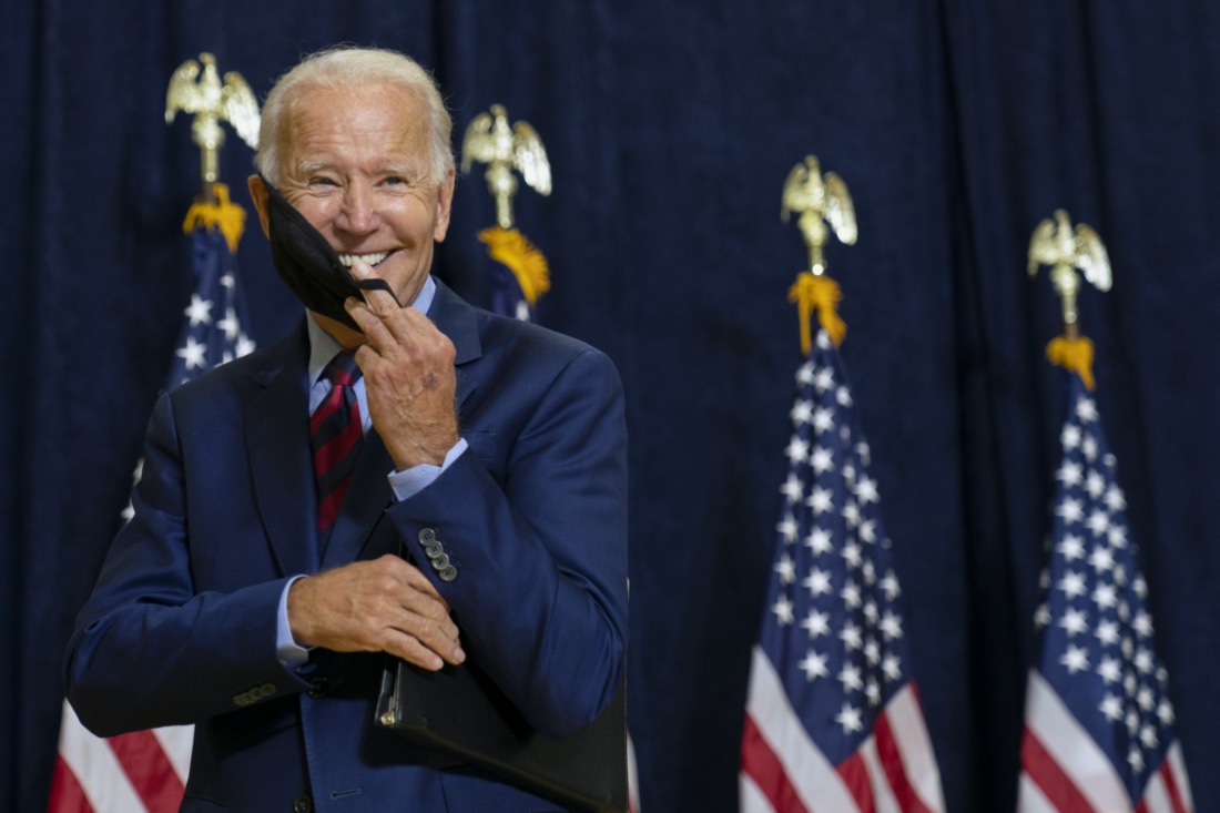 Democratic presidential candidate former Vice President Joe Biden smiles as he puts on his face mask after speaking to media in Wilmington, Del., on Sept. 4, 2020. (AP Photo/Carolyn Kaster)