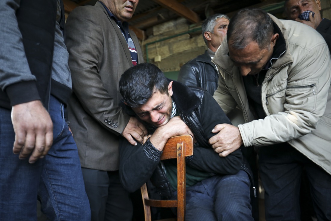 The father of 7-year-old Aysu Isgandarova, who died during shelling by Armenian forces in the struggle over the region of Nagorno-Karabakh, mourns during her funeral in Garayusifli, Azerbaijan, on Oct. 28, 2020. (AP Photo/Aziz Karimov)