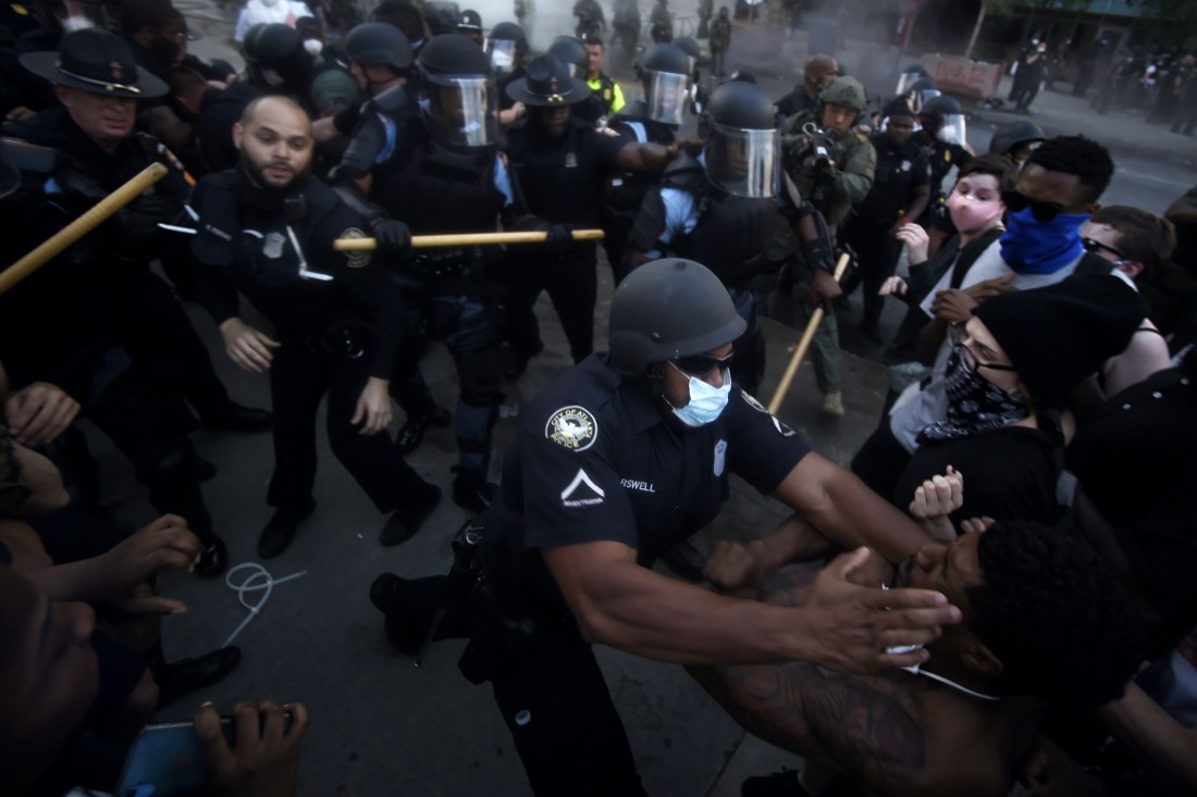 Police officers and protesters clash in Atlanta on May 29, 2020, during a protest in response to George Floyd's death in police custody in Minneapolis. Floyd, a Black man, died after a white police officer pressed a knee into his neck for several minutes even after he stopped moving and pleading for air. (AP Photo/Mike Stewart)