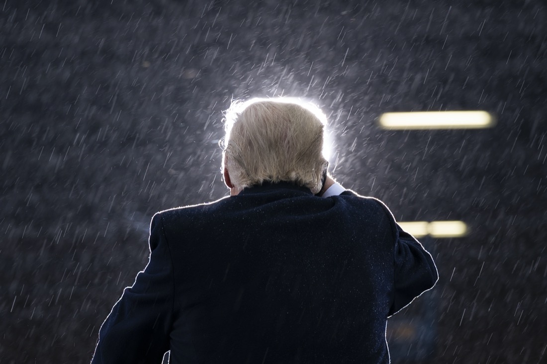 President Donald Trump speaks in the rain during a campaign rally at Capital Region International Airport in Lansing Mich., on Oct. 27, 2020. (AP Photo/Evan Vucci)