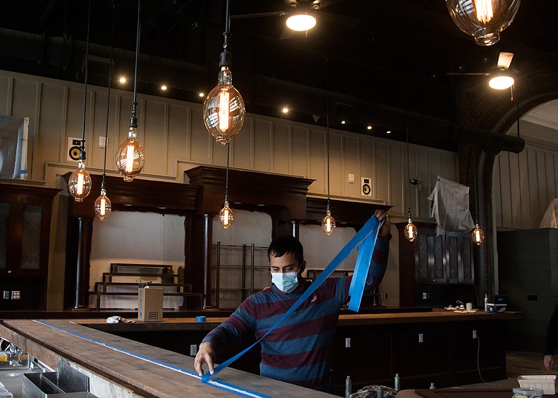 Staff photo by Troy Stolt / Ivan Munoz works to put the finishing touches on the bar inside Nic & Norman's on Tuesday, Dec. 1, 2020 in Chattanooga, Tenn. The restaurant, which planned to open in the spring of 2020 before the pandemic, now plans to open open its doors sometime next week.