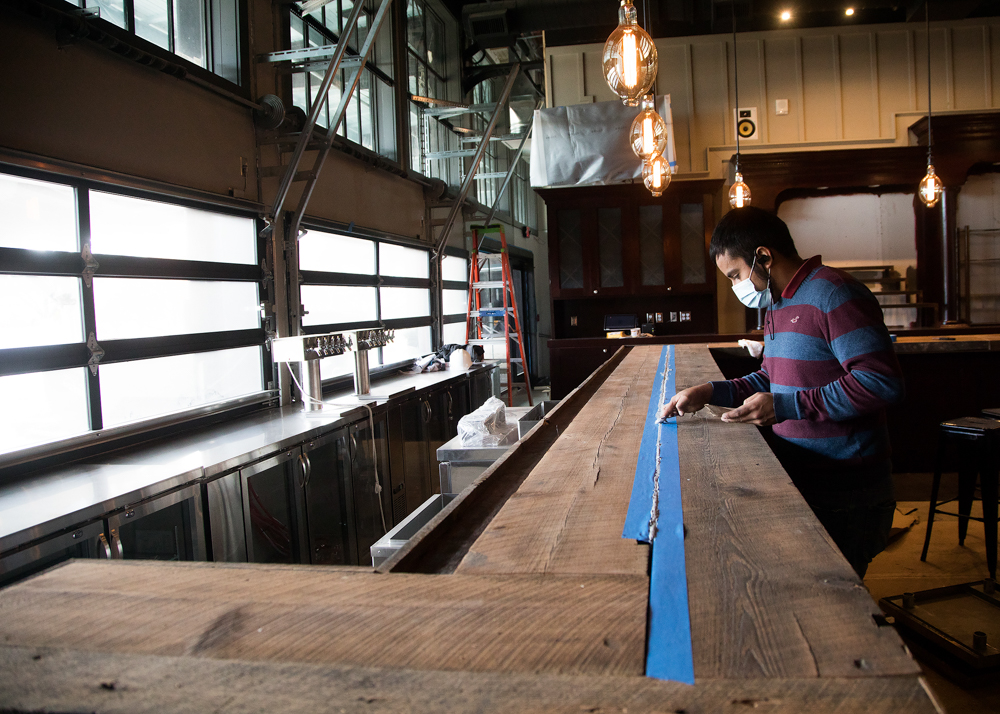 Staff photo by Troy Stolt / Ivan Munoz works to put the finishing touches on the bar inside Nic & Norman's on Tuesday, Dec. 1, 2020 in Chattanooga, Tenn. The restaurant, which planned to open in the spring of 2020 before the pandemic, now plans to open open its doors sometime next week.