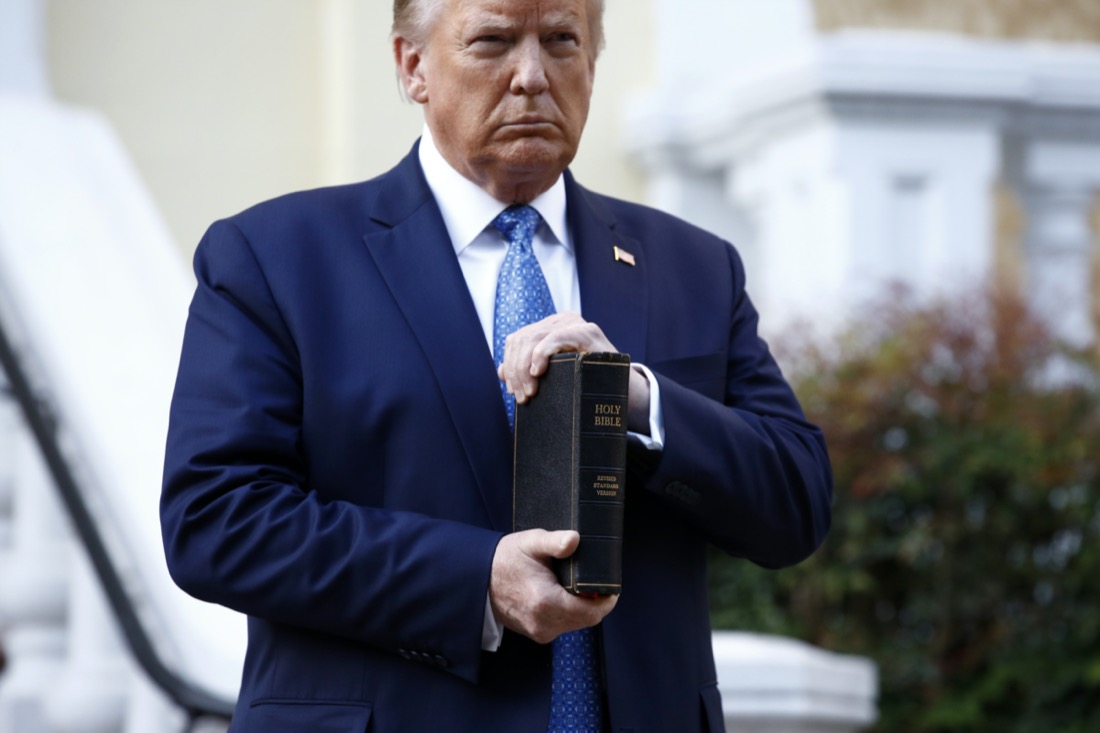 President Donald Trump holds a Bible as he stands outside St. John's Church across Lafayette Park from the White House in Washington on June 1, 2020, after law enforcement officers used tear gas and other riot control tactics to forcefully clear peaceful protesters from the area. (AP Photo/Patrick Semansky)