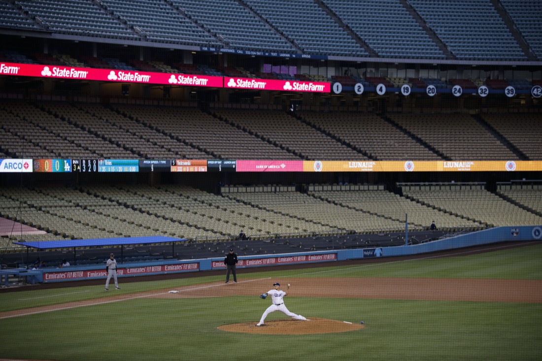 With the seats at Dodger Stadium empty, Los Angeles Dodgers starting pitcher Julio Urias throws to a San Francisco Giants batter during the third inning of a baseball game on July 26, 2020, in Los Angeles. (AP Photo/Jae C. Hong)