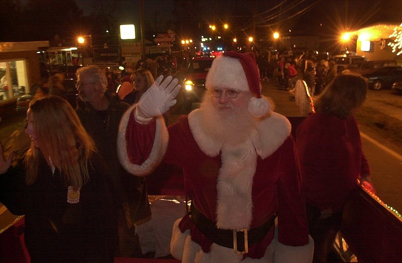 Staff File Photo / Santa Claus waves to parade goers at a previous Ringgold Down Home Christmas parade. This year's parade is scheduled Friday night.