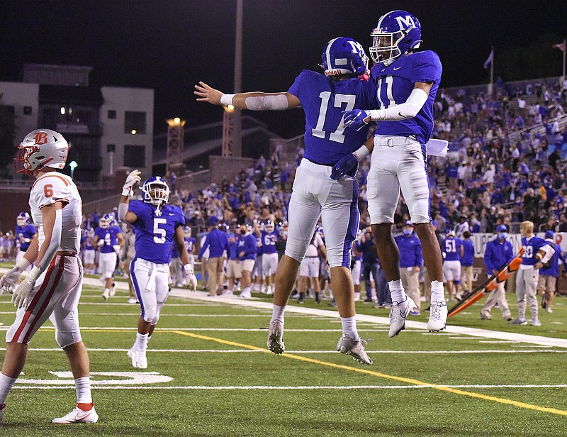 Staff photo by Matt Hamilton / McCallie's John David Tessman (17) and Eric Rivers leap in celebration after the Blue Tornado scored a touchdown against rival Baylor on Oct. 2 at Finley Stadium. McCallie is trying to repeat as TSSAA Division II-AAA state champion and win the program's third title overall.
