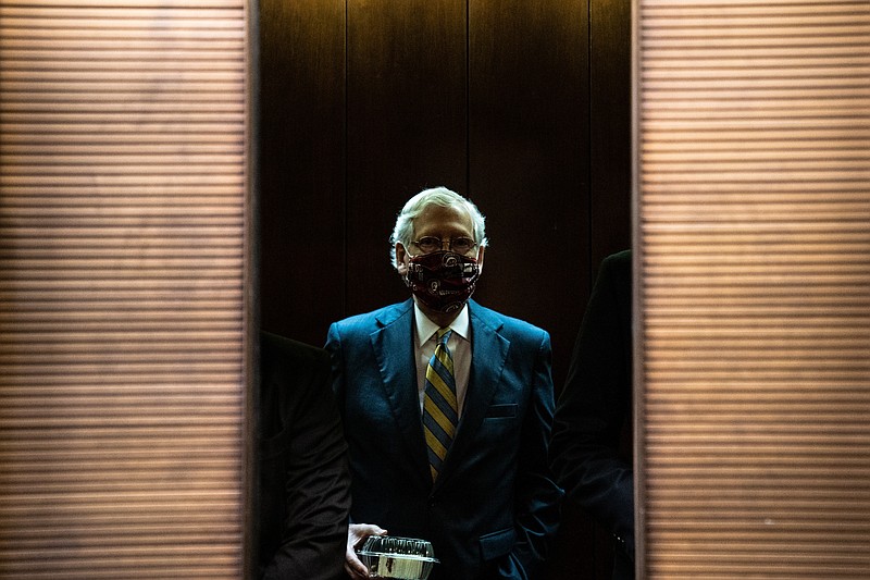 New York Times file photo by Anna Moneymaker/Senate Majority Leader Mitch McConnell, R-Kentucky, rides an elevator following a luncheon with other Senate Republicans in Washington in July. McConnell is again stalling relief for the pandemic-wracked economy.