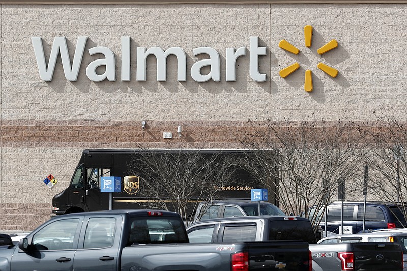 This March 17, 2020 photo shows a Walmart store in Mebane, N.C. Walmart says for the fourth time during the pandemic it will give its 1.5 million U.S. part-time and full-time employees additional cash bonuses for their work. The move, announced Thursday, Dec. 3, follows similar announcements in recent weeks by such retailers as Target, Lowe's, and Amazon which are offering another round of bonuses as virus cases surge around the country. (AP Photo/Gerry Broome)