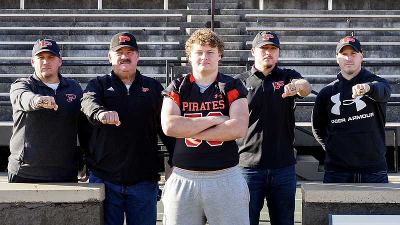 Staff photo by C.B. Schmelter / Stone family members, from left, Wesley, Johnny, Jared, Jake and Matt pose at South Pittsburg High School's Beene Stadium on Tuesday. Johnny played on South Pittsburg's 1969 state championship team, his sons Wesley (1994) and Matt (1999) were also on state championship teams for the Pirates, and grandson Jake (2010) was, too. Now grandson Jared is on this year's team that is playing for the Class 1A title against Fayetteville.