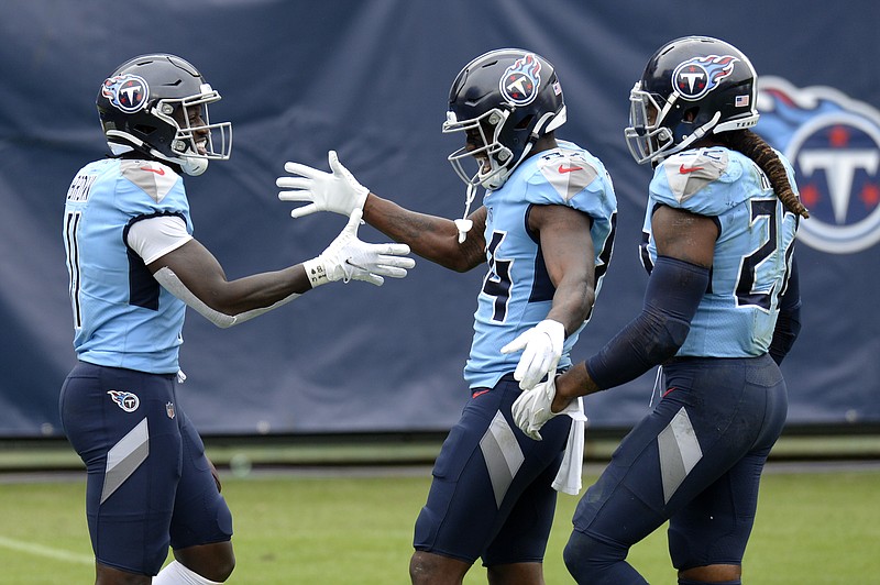 A.J. Brown, left, is congratulated by fellow Tennessee Titans wide receiver Corey Davis, center, and running back Derrick Henry after making a 73-yard touchdown catch against the Pittsburgh Steelers on Oct. 25 in Nashville. Brown and Davis have given the Titans the needed threats at receiver to boost Henry's effectiveness on the ground by keeping defenses guessing.