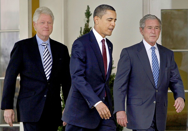 In this Jan. 16, 2010, file photo President Barack Obama, center, walks out of the Oval Office of the White House with former Presidents Bill Clinton, left, and George W. Bush, right, to deliver remarks in the Rose Garden at the White House in Washington. Three former presidents say they'd be willing to take a coronavirus vaccine publicly, once one becomes available, to encourage all Americans to get inoculated against a disease that has already killed more than 273,000 people nationwide. (AP Photo/Pablo Martinez Monsivais, File)