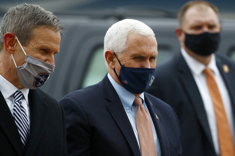 Vice President Mike Pence, right, and Tennessee Gov. Bill Lee talk on the tarmac at the Air National Guard 164th Airlift Wing prior to a roundtable discussion about Operation Warp Speed on Thursday, Dec. 3, 2020, in Memphis, Tenn. (Joe Rondone/The Commercial Appeal via AP)