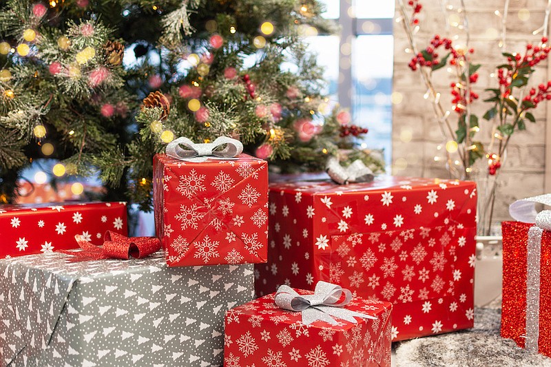 Gift boxes under a Christmas tree, decorations, red wrapping paper presents, Christmas holiday. / Photo credit: Getty Images/iStockphoto/Inna Dodor