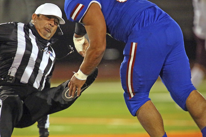 AP photo by Joel Martinez / Texas high school football referee Fred Gracia falls to the turf after being charged by Edinburg senior defensive lineman Emmanuel Duron during a game against Pharr-San Juan-Alamo on Thursday night. Duron had already been ejected from the game when he ran from the sideline and slammed into the official.