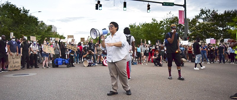 Staff Photo by Robin Rudd / Marie Mott addresses the protesters as the march pauses at the intersection of Houston and Market Streets. Protesters gathered at Miller Park and marched south past some of Chattanooga's tourism icons in protest of police brutality on June 17, 2020.