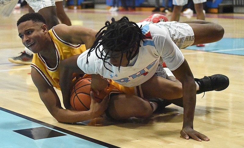 Staff photo by Matt Hamilton / Howard's Jaden Jenkins, left, competes with Brainerd's Xiyeer Lattimore for possession of the basketball during Saturday's district game at Howard.