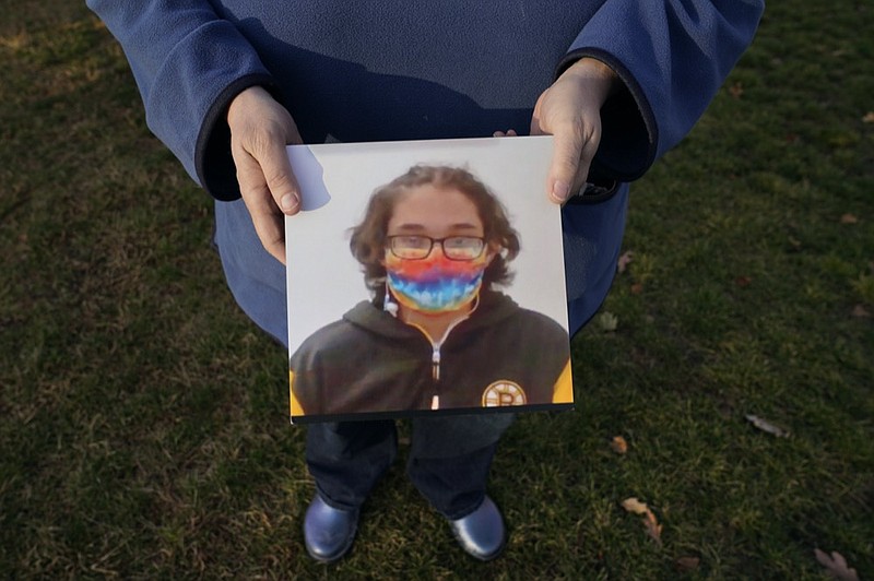 Laura Dilts, of Barre, Mass., holds a photograph of her 16-year-old son outside the Worcester Recovery Center, where he is a resident patient receiving assistance for his mental health, Monday, Nov. 23, 2020, in Worcester, Mass. The coronavirus pandemic has led to rising emergency room visits and longer waits for U.S. children and teens facing mental health issues. (AP Photo/Charles Krupa)



