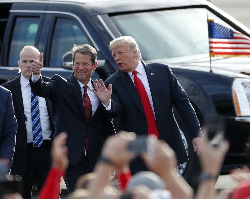 In this Nov. 4, 2018, file photo, then-Georgia Republican gubernatorial candidate Brian Kemp, left, walks with President Donald Trump as Trump arrives for a rally in Macon, Ga. President Trump said Sunday, Nov. 29, 2020, he was "ashamed" for endorsing the Republican governor of Georgia after he lost in the state to Democrat Joe Biden. Trump said on Fox News that Gov. Brian Kemp has "done absolutely nothing" to question the state's results. (AP Photo/John Bazemore, File)


