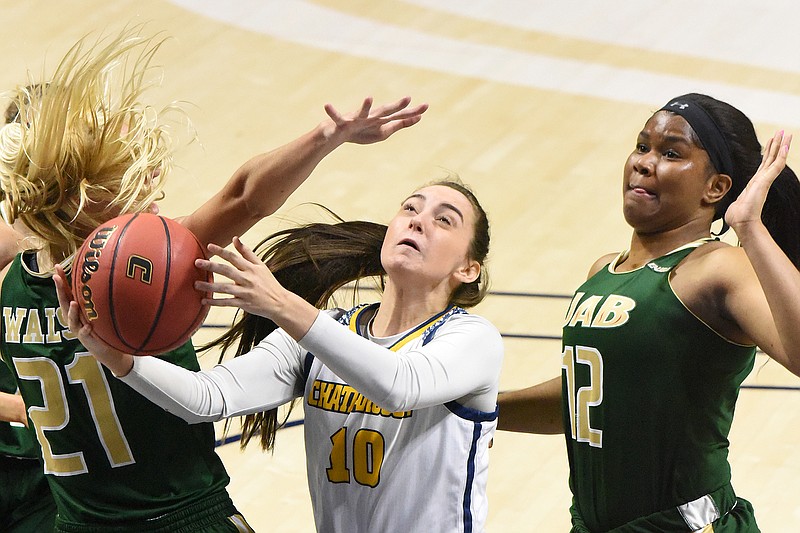 Staff photo by Matt Hamilton / UTC's Dena Jarrells shoots as UAB's Maddie Walsh, left, and Lamiracle Sims defend during Sunday afternoon's game at McKenzie Arena. It was the opener for UTC, which lost 78-58.