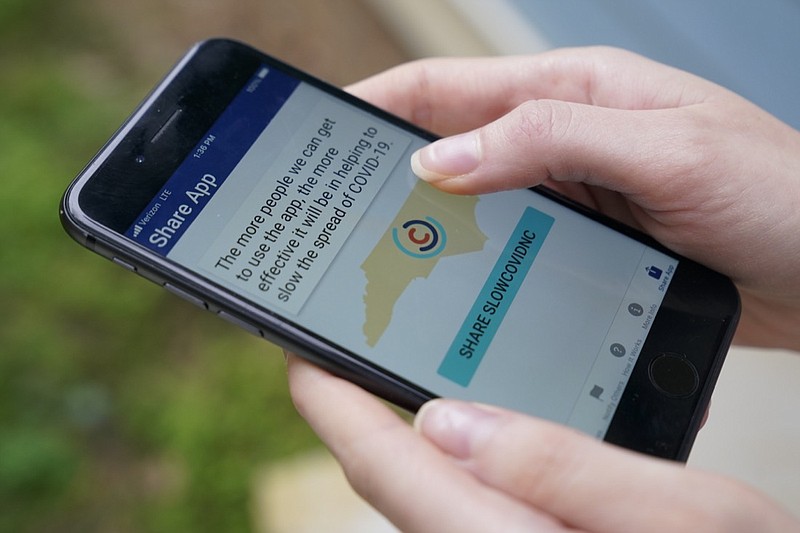North Carolina' s cell phone app contact tracing SlowCOVIDNC is shown on Friday, Dec. 4, 2020, in Charlotte, N.C. An analysis shows that few Americans are utilizing contact tracing technology launched in a host of U.S. states and territories. (AP Photo/Chris Carlson)