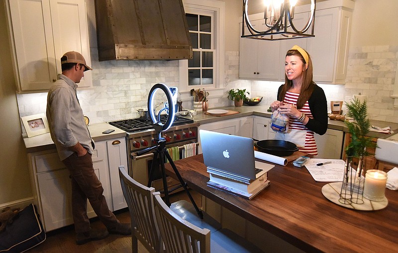 Staff Photo by Matt Hamilton / Jill Allen leads a virtual cooking class at her home to benefit Girls Inc. as her husband, Jeff, manages the various camera angles.