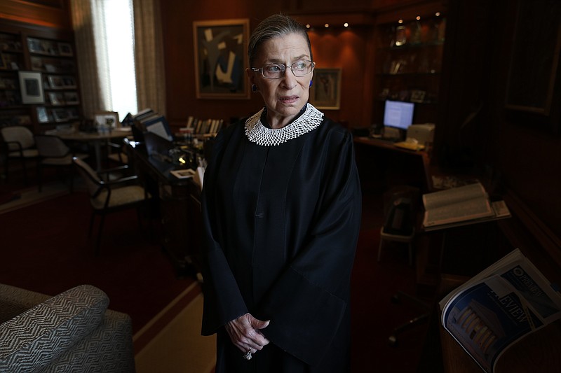 In this July 24, 2013, file photo, Associate Justice Ruth Bader Ginsburg poses for a photo in her chambers at the Supreme Court in Washington, before an interview with The Associated Press. Ginsburg, 87, developed a cultlike following over her more than 27 years on the bench, especially among young women who appreciated her lifelong, fierce defense of women's rights. She died Sept. 18, 2020. (AP Photo/Charles Dharapak, File)