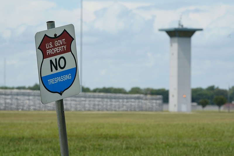 In this Aug. 28, 2020, file photo, a no trespassing sign is displayed outside the federal prison complex in Terre Haute, Ind. As Donald Trump's presidency winds down, his administration is throttling up the pace of federal executions despite a surge of COVID-19 cases in prison, announcing plans for five executions just days before the Jan. 20 inauguration of death penalty foe Joe Biden. Attorney General William Barr defends the action in an interview with The Associated Press and says he will likely schedule additional executions before leaving the Cabinet. (AP Photo/Michael Conroy, File)
