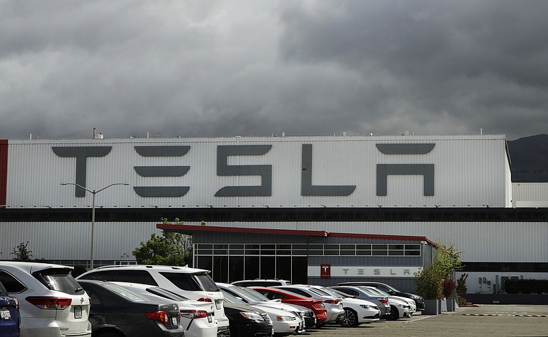 FILE - This May 12, 2020 file photo photo shows the Tesla plant in Fremont, Calif. Tesla is looking to raise up to $5 billion in capital through a stock offering as the electrical vehicle and solar panel maker seeks to take advantage of strong demand for its products. (AP Photo/Ben Margot, File)