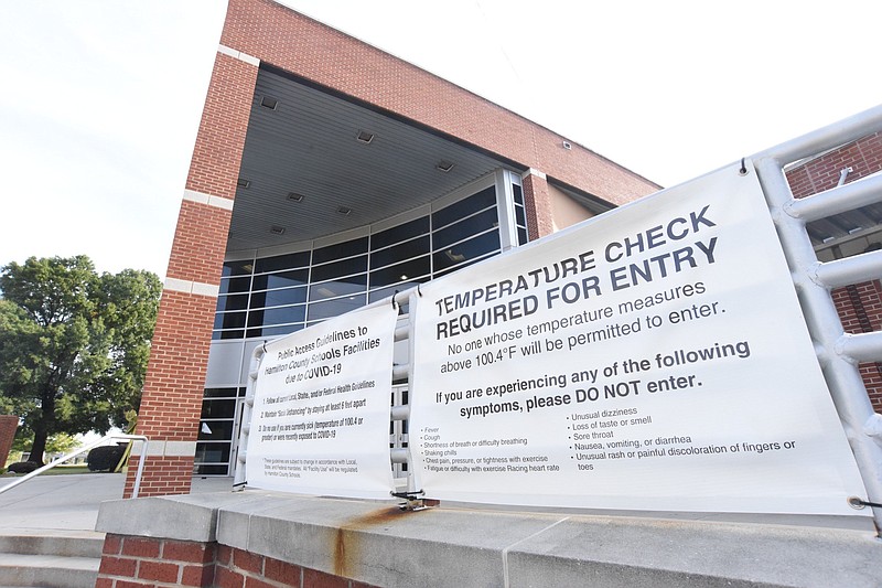 Staff Photo by Matt Hamilton / A sign, on October 8, 2020, in front of Howard School warns not to enter if showing signs of COVID-19.