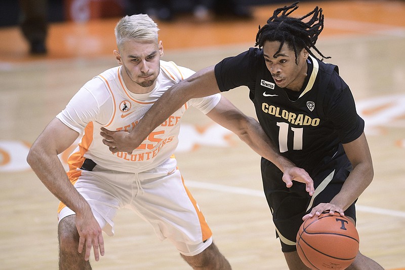 Tennessee's Santiago Vescovi (25) defends against Colorado's Keeshawn Barthelemy (11) during an NCAA college basketball game Tuesday, Dec. 8, 2020, in Knoxville, Tenn. (Caitie McMekin/Knoxville New-Sentinel via AP, Pool)