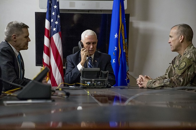 FILE - In this Nov. 23, 2019, file photo Vice President Mike Pence, accompanied by U.S. Ambassador to Iraq Matthew Tueller, left, and Lt. Gen. Pat White, right, takes a phone call with Iraqi Prime Minister Adil Abdul-Mahdi at Al Asad Air Base, Iraq. White is the Fort Hood commander and he is facing the grim task of rebuilding trust and turning around an installation that has one of the highest rates of murder, sexual assault and harassment in the Army. (AP Photo/Andrew Harnik, File)