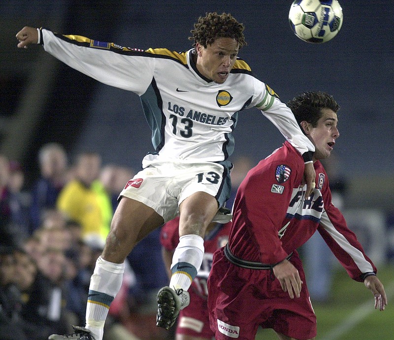 AP photo by Fred Jewell / The Los Angeles Galaxy's Cobi Jones heads the ball above the Chicago Fire's Carlos Bocanegra during an MLS playoff game on Oct. 17, 2011, in Chicago. Jones, one of the league's original players who spent his entire 11-year career with the Galaxy, was named one of the MLS 25 Greatest on Wednesday.