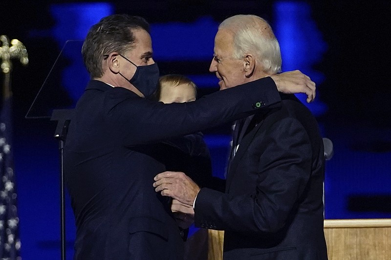 In this Nov. 7, 2020, file photo, President-elect Joe Biden, right, embraces his son Hunter Biden, left, in Wilmington, Del. Biden's son Hunter says he has learned from federal prosecutors that his tax affairs are under investigation. (AP Photo/Andrew Harnik, Pool)