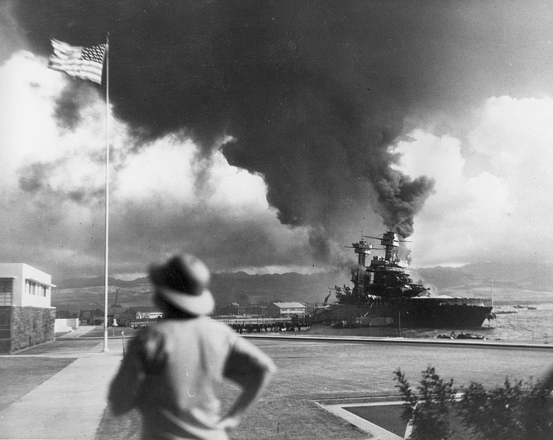 Photo by The Associated Press / In this Dec. 7, 1941, file photo, American ships burn during the Japanese attack on Pearl Harbor, Hawaii.